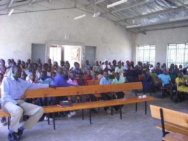 Orphans and guardians gather for spiritual teaching prior to the Christmas meal. Orphans and guardians gather for spiritual teaching prior to the Christmas meal.